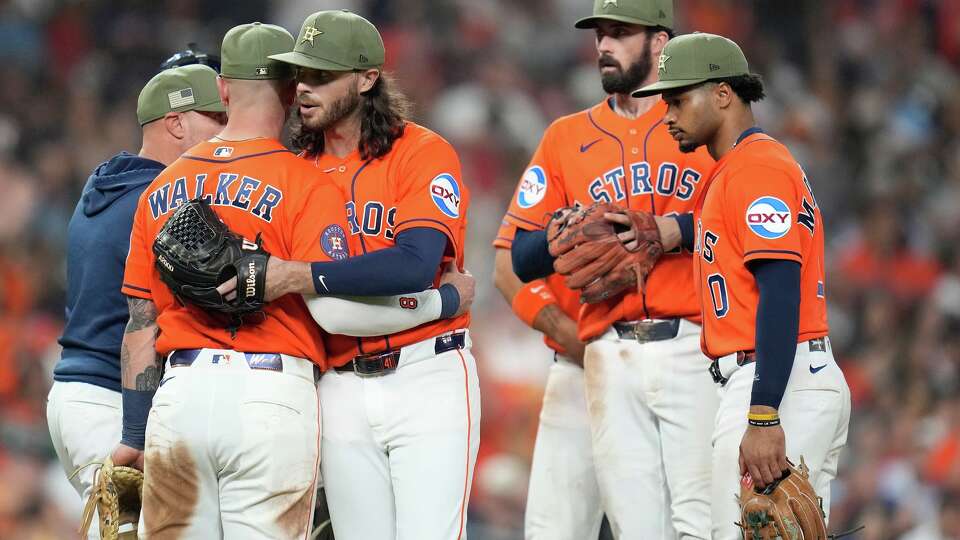 Houston Astros starting pitcher Spencer Arrighetti, center, hugs Christian Walker after Texas Rangers' Justin Foscue's single broke up Arrighetti's no-hit bid during the eighth inning of a baseball game, Friday, May 15, 2026, in Houston. (AP Photo/Karen Warren)