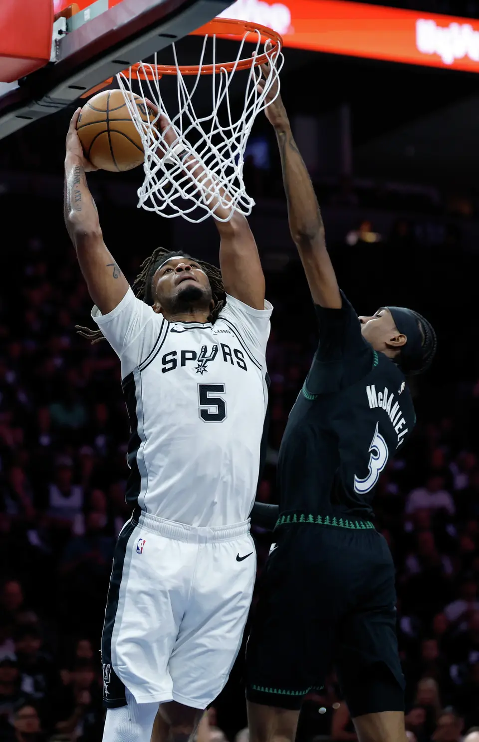 San Antonio Spurs guard Stephon Castle (5) prepares to dunk over Minnesota Timberwolves forward Jaden McDaniels (3) during the first half of Game 6 of the Western Conference semifinals at Target Center in Minneapolis, Friday, May 15, 2026.