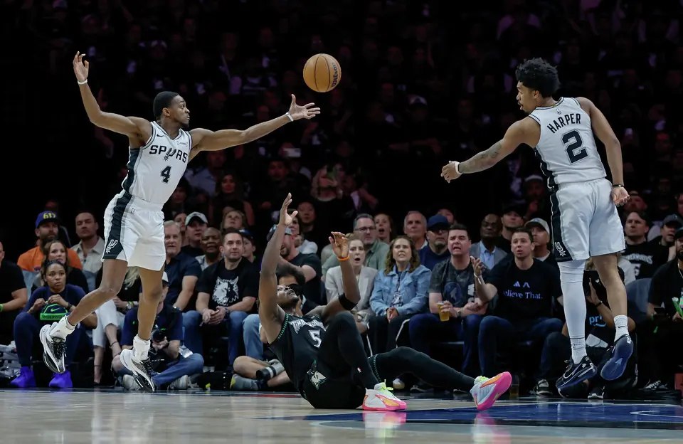 Minnesota Timberwolves guard Anthony Edwards (5) goes down as San Antonio Spurs guard De'Aaron Fox (4) recovers a loose ball during the first half of Game 6 of the Western Conference semifinals at Target Center in Minneapolis, Friday, May 15, 2026.