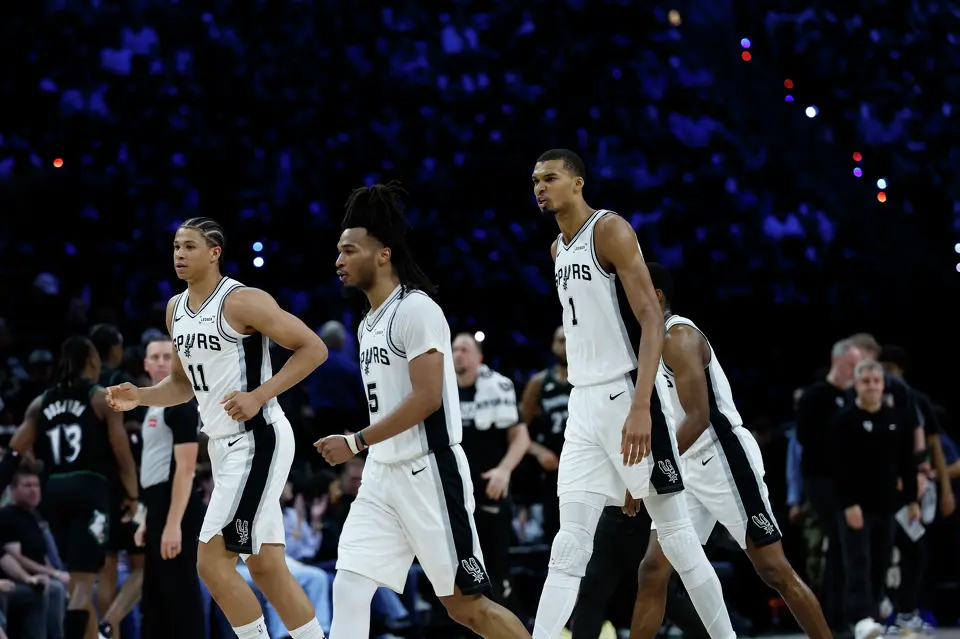 San Antonio Spurs forward Carter Bryant (11), San Antonio Spurs guard Stephon Castle (5) and San Antonio Spurs forward Victor Wembanyama (1) walk off the court at the end of the first half of Game 6 of the Western Conference semifinals at Target Center in Minneapolis, Friday, May 15, 2026.