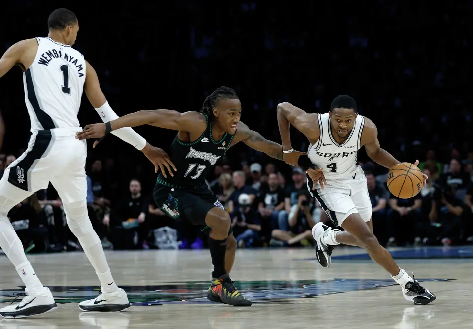 San Antonio Spurs guard De'Aaron Fox (4) gets around Minnesota Timberwolves guard Ayo Dosunmu (13) after Spurs forward Victor Wembanyama (1) sets the pick during the first half of Game 6 of the Western Conference semifinals at Target Center in Minneapolis, Friday, May 15, 2026.