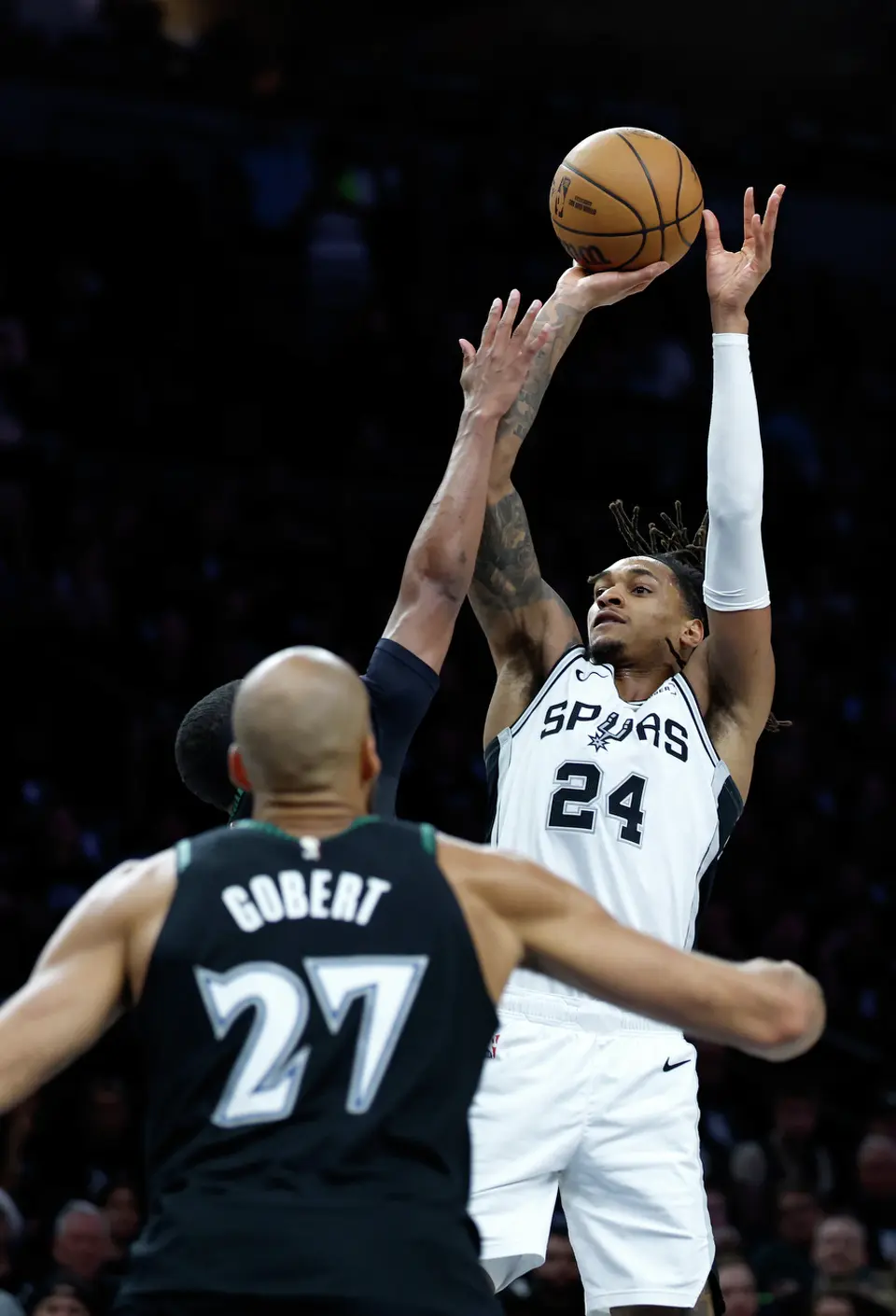 San Antonio Spurs guard Devin Vassell (24) throws up a jump shot over the Minnesota defense during the first half of Game 6 of the Western Conference semifinals at Target Center in Minneapolis, Friday, May 15, 2026.