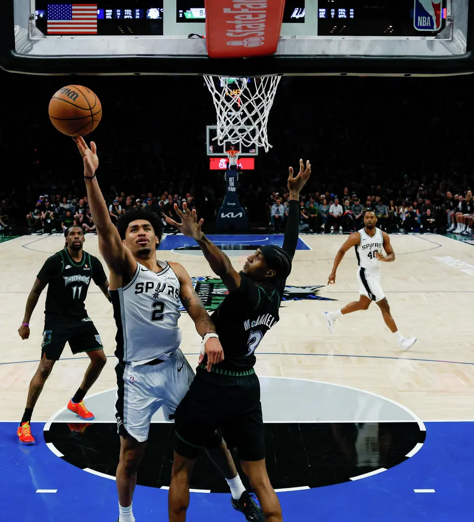 San Antonio Spurs guard Dylan Harper (2) goes up for a shot over Minnesota Timberwolves forward Jaden McDaniels (3) during the second half of Game 6 of the Western Conference semifinals at Target Center in Minneapolis, Friday, May 15, 2026. The Spurs defeated the Timberwolves 139-109 and will advance to the Western Conference Finals to face the Oklahoma City Thunder.