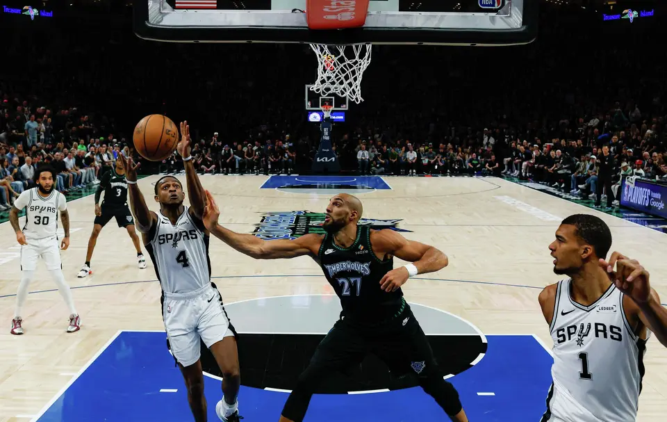 San Antonio Spurs guard De'Aaron Fox (4) pulls down a rebound over Minnesota Timberwolves center Rudy Gobert (27) during Game 6 of the Western Conference semifinals at Target Center in Minneapolis, Friday, May 15, 2026. The Spurs defeated the Timberwolves 139-109 and will advance to the Western Conference Finals to face the Oklahoma City Thunder.