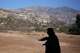 Norma Meza Calles, a Kumeyaay Nation leader, gestures as she speaks of the sacred importance of Kuuchamaa Mountain, behind, at a wellness center, Friday, May 1, 2026, in Tecate, Mexico.
