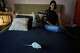 Dominique Verdier watches Carlota, a former lab rat she adopted, walk on her bed in Buenos Aires, Argentina, Friday, May 15, 2026.