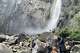 A crowd gathers off-trail at Lower Yosemite Falls to take a closer look at the waterfall Saturday.