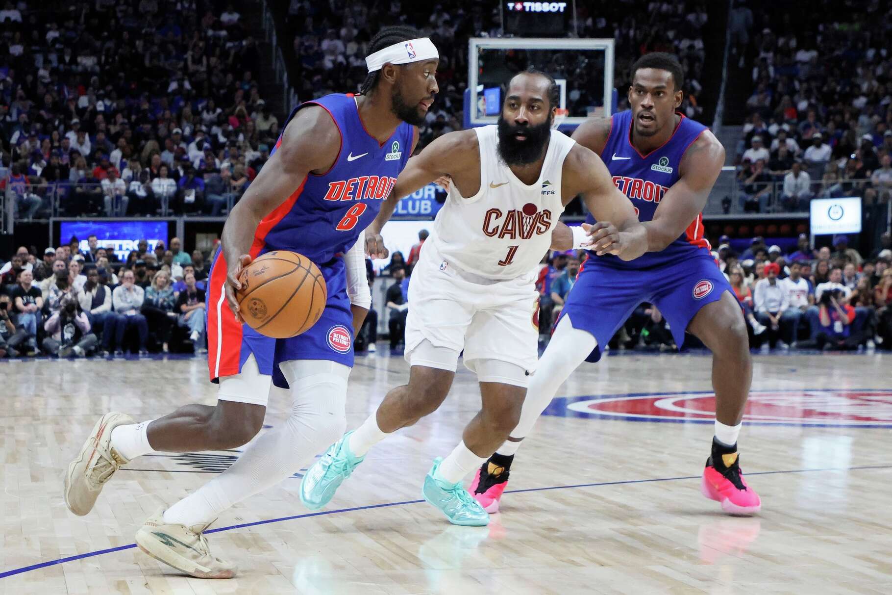 Detroit Pistons guard Caris LeVert (8) drives to the basket against Cleveland Cavaliers guard James Harden (1) with Pistons center Jalen Duren, right, helping on the play during the first half in Game 7 of a second-round NBA playoffs basketball series Sunday, May 17, 2026, in Detroit.