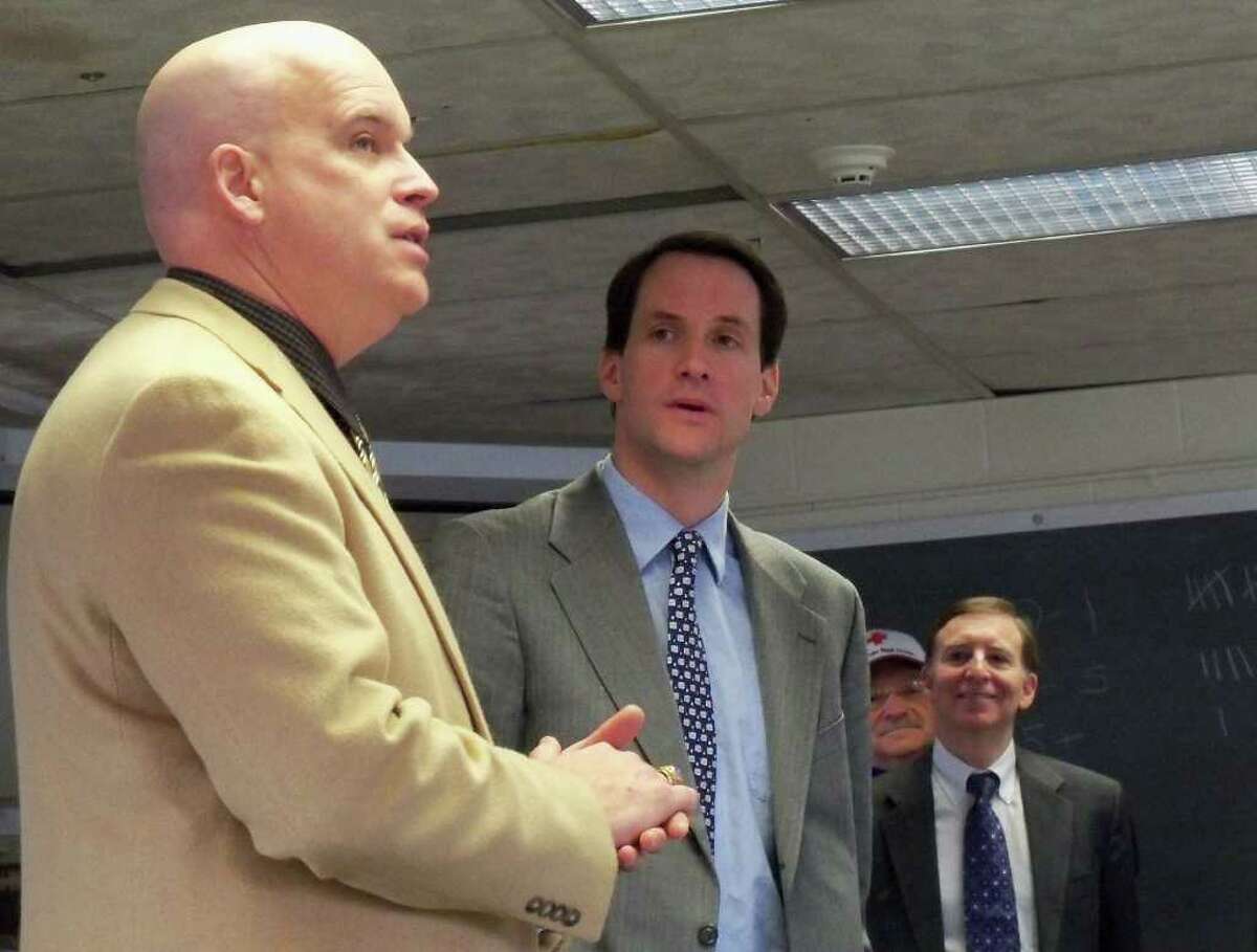 Robert Kenny, left, the Region 1 coordinator for the state Department of Emergency Management Homeland Security, announces the acquisition of 14 emergency shelter trailers Monday at the Fairfield Regional Fire School along with U.S. Rep. Jim Himes, D-Connecticut and First Selectman Kenneth Flatto, right.