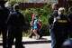 Children hold hand as they walk near the scene of a shooting outside the Islamic Center of San Diego Monday, May 18, 2026, in San Diego.