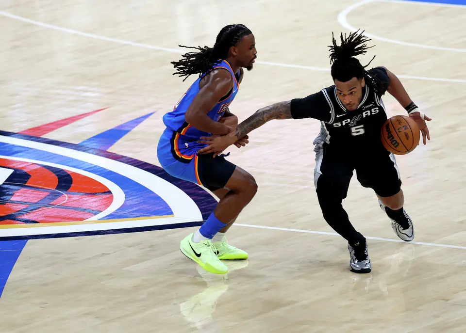 San Antonio Spurs guard Stephon Castle (5) drives up the court and past Oklahoma City Thunder guard Cason Wallace (22) during the first half of Game 1 of the Western Conference Finals at Paycom Center in Oklahoma City, Monday, May 18, 2026.