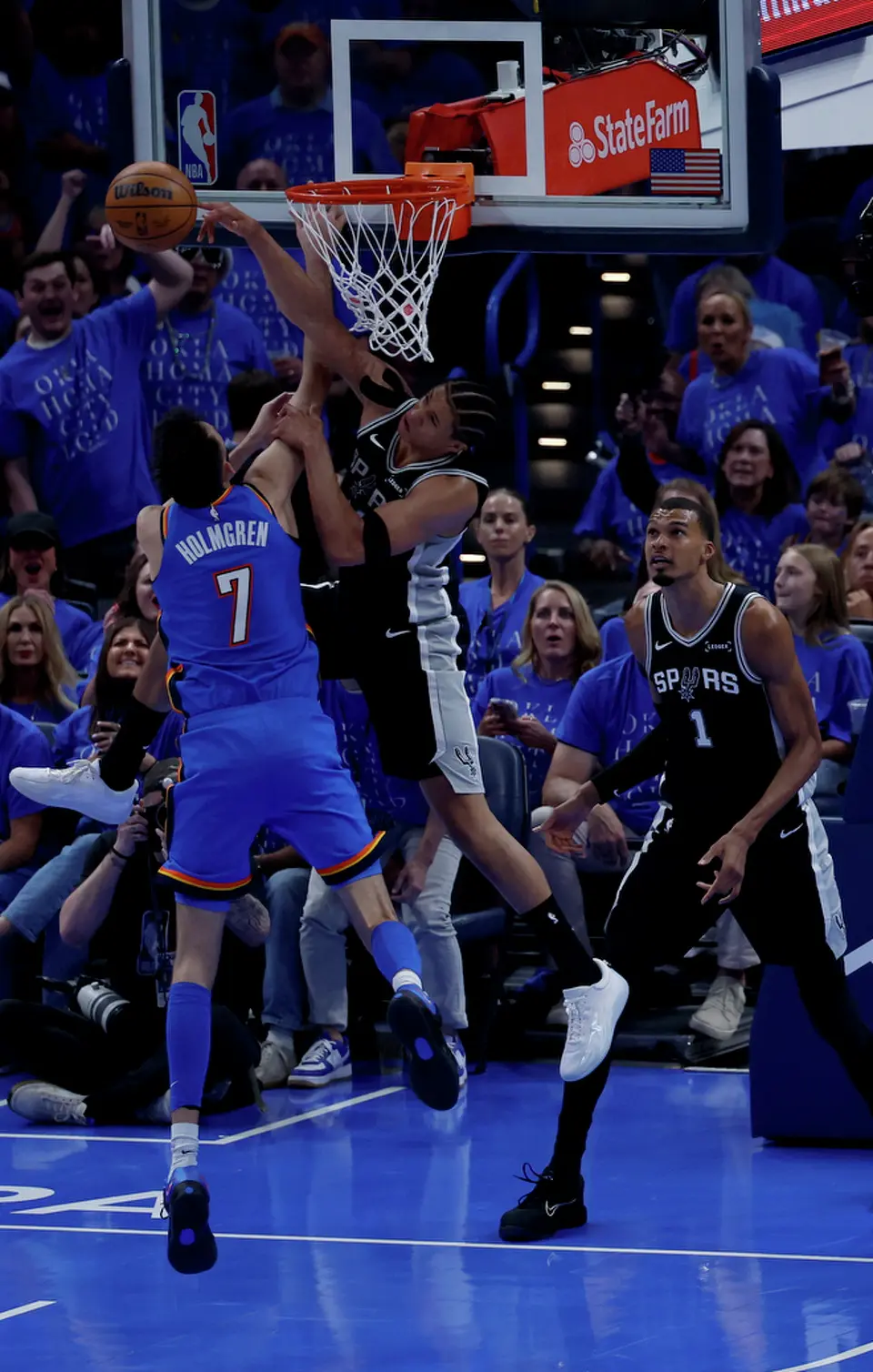 San Antonio Spurs forward Carter Bryant (11) gets the blocked shot against Oklahoma City Thunder center Chet Holmgren (7) during the first half of Game 1 of the Western Conference Finals at Paycom Center in Oklahoma City, Monday, May 18, 2026.