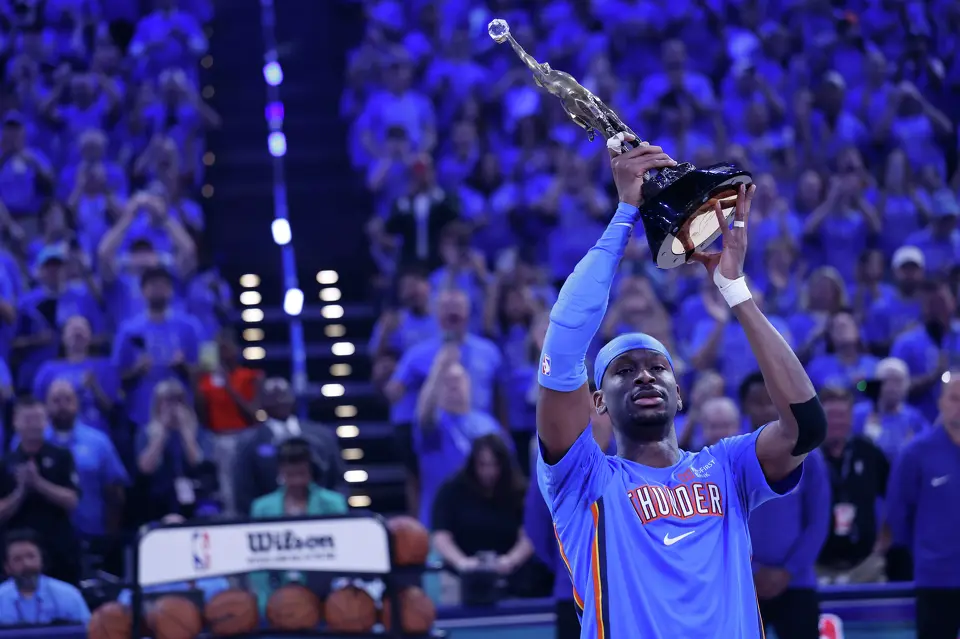 Oklahoma City Thunder guard Shai Gilgeous-Alexander (2) hoists the NBA’s most valuable player trophy before Game 1 of the Western Conference Finals between the Oklahoma City Thunder and the San Antonio Spurs at Paycom Center in Oklahoma City, Monday, May 18, 2026.
