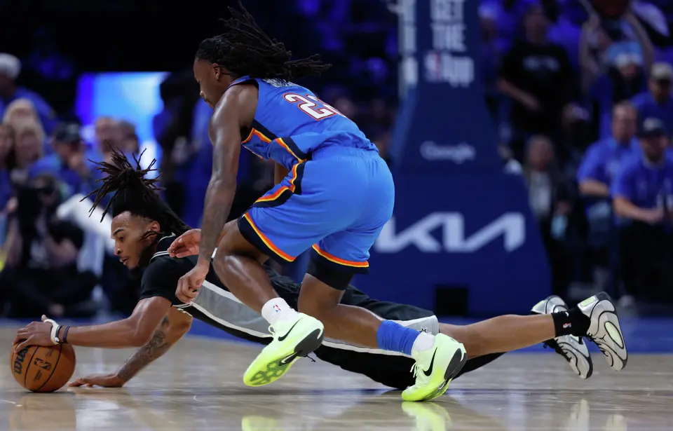 San Antonio Spurs guard Stephon Castle (5) dives for a loose ball under Oklahoma City Thunder guard Cason Wallace (22) during the third quarter of Game 1 of the Western Conference Finals at Paycom Center in Oklahoma City, Monday, May 18, 2026.