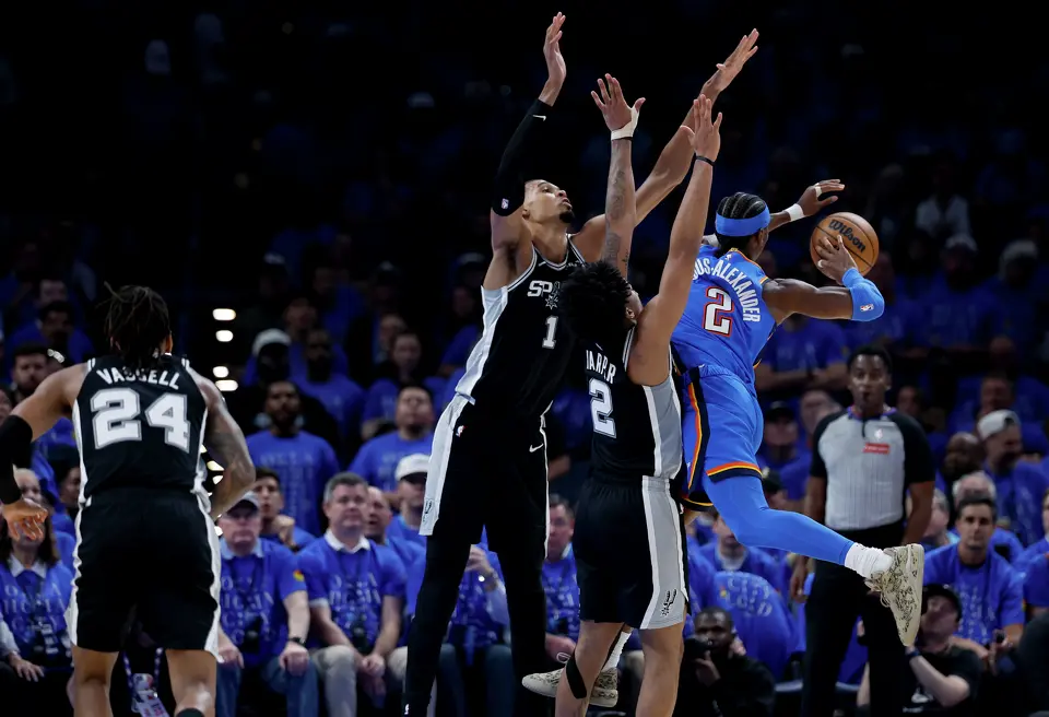 San Antonio Spurs forward Victor Wembanyama (1) and San Antonio Spurs guard Dylan Harper (2) force Oklahoma City Thunder guard Shai Gilgeous-Alexander (2) to pass the ball off during the third quarter of Game 1 of the Western Conference Finals at Paycom Center in Oklahoma City, Monday, May 18, 2026.