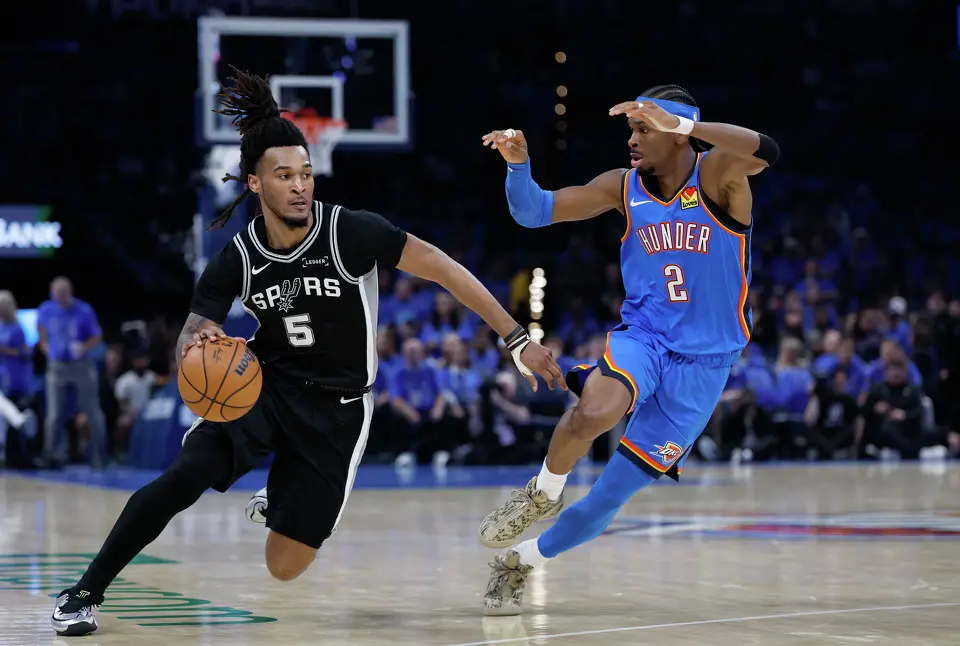 San Antonio Spurs guard Stephon Castle (5) drives up the floor with Oklahoma City Thunder guard Shai Gilgeous-Alexander (2) in tow during the third quarter of Game 1 of the Western Conference Finals at Paycom Center in Oklahoma City, Monday, May 18, 2026.