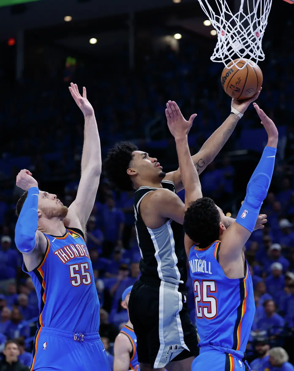 San Antonio Spurs guard Dylan Harper (2) goes for the layup past Oklahoma City Thunder guard Ajay Mitchell (25) and Oklahoma City Thunder center Isaiah Hartenstein (55) during the third quarter of Game 1 of the Western Conference Finals at Paycom Center in Oklahoma City, Monday, May 18, 2026.