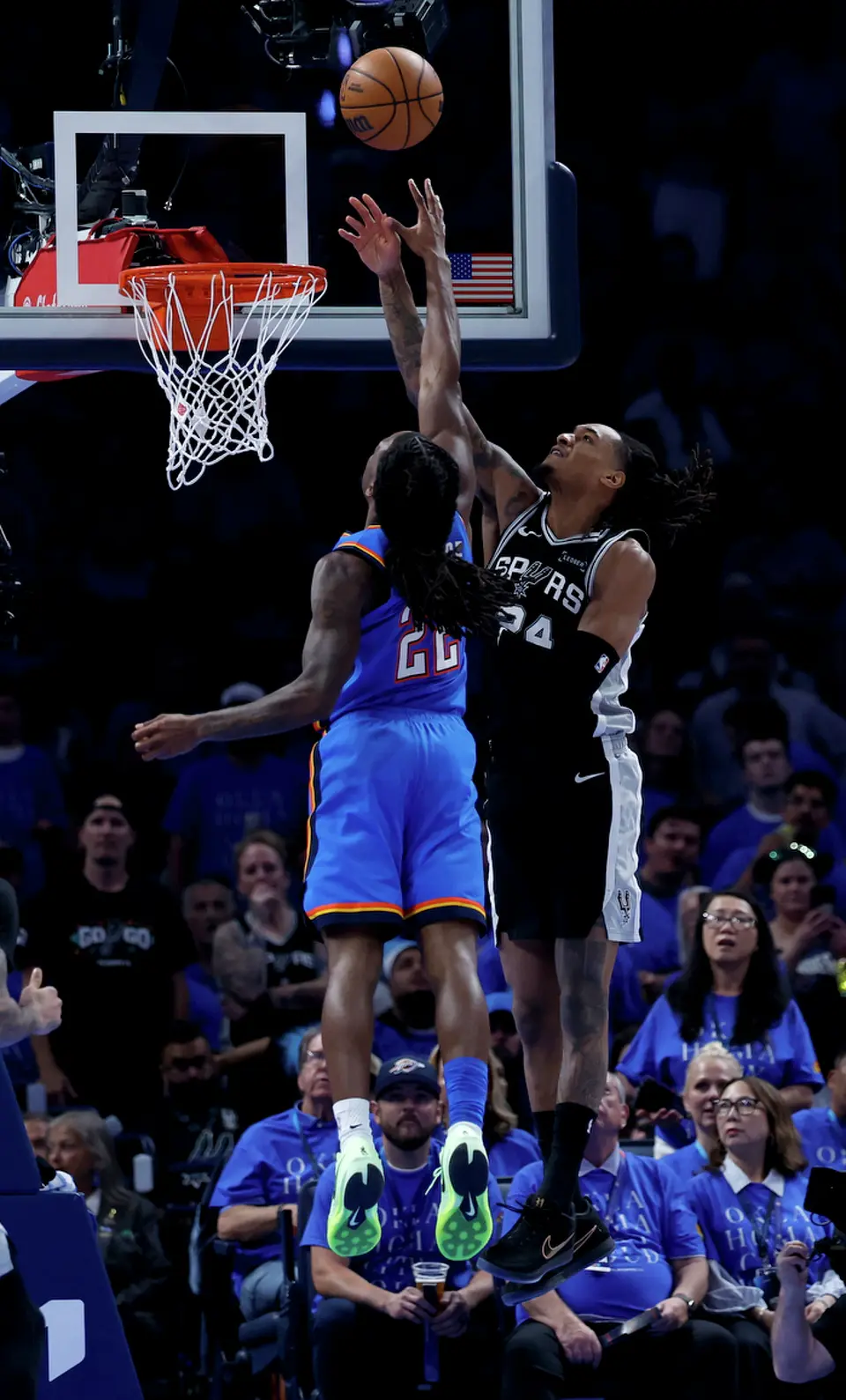 San Antonio Spurs guard Devin Vassell (24) tries to block a layup by Oklahoma City Thunder guard Cason Wallace (22) during the third quarter of Game 1 of the Western Conference Finals at Paycom Center in Oklahoma City, Monday, May 18, 2026.