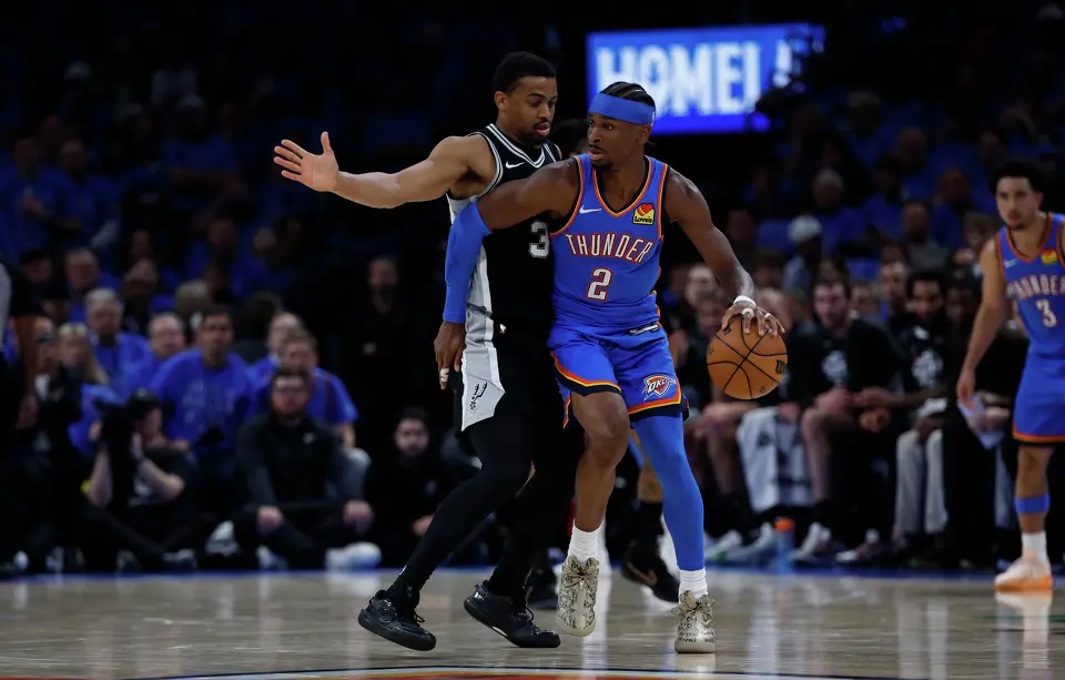 San Antonio Spurs forward Keldon Johnson (3) guards Oklahoma City Thunder guard Jared McCain (3) during the third quarter of Game 1 of the Western Conference Finals at Paycom Center in Oklahoma City, Monday, May 18, 2026.