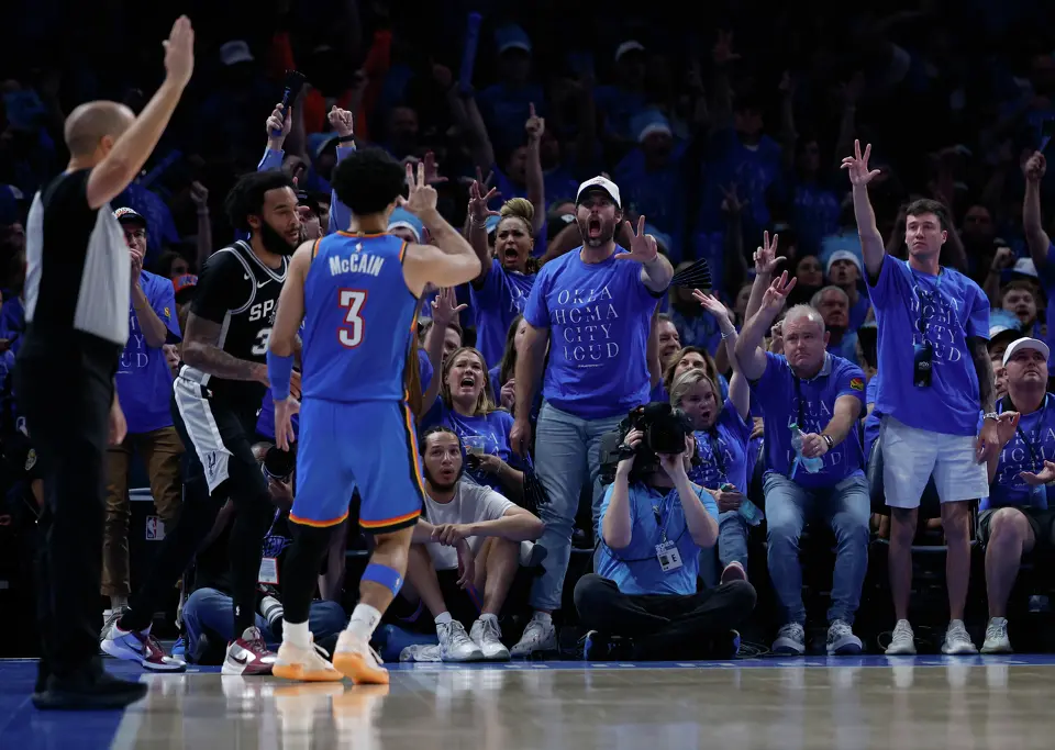 Fans flash the 3-point sign after Oklahoma City Thunder guard Jared McCain (3) makes a 3 point basket during the third quarter of Game 1 of the Western Conference Finals at Paycom Center in Oklahoma City, Monday, May 18, 2026.