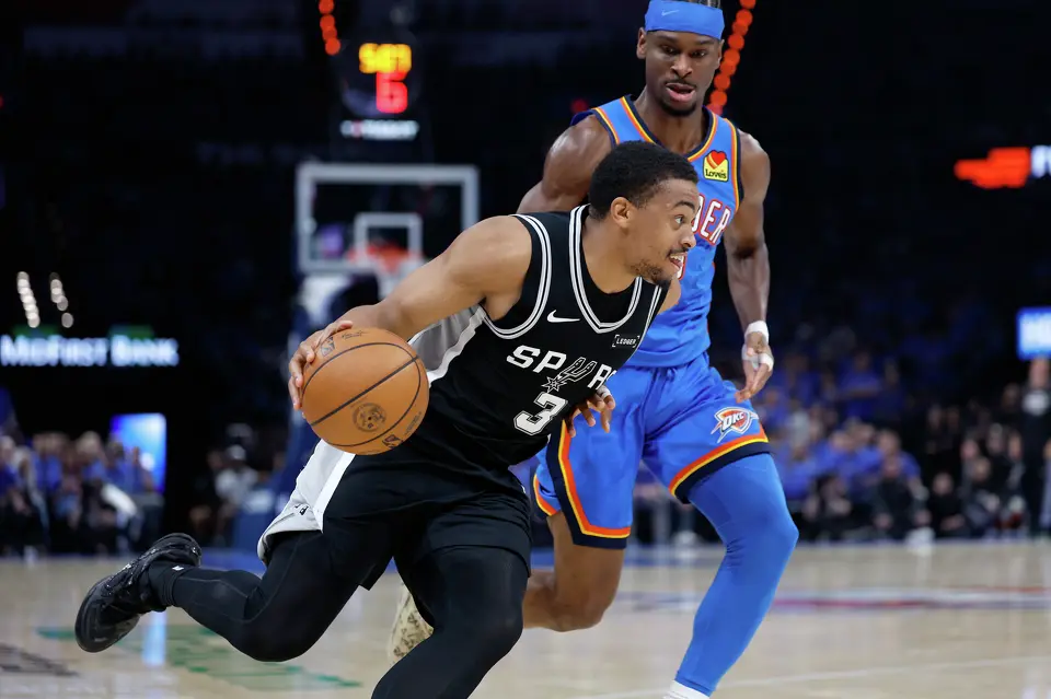 San Antonio Spurs forward Keldon Johnson (3) drives past Oklahoma City Thunder guard Shai Gilgeous-Alexander (2) during the third quarter of Game 1 of the Western Conference Finals at Paycom Center in Oklahoma City, Monday, May 18, 2026.
