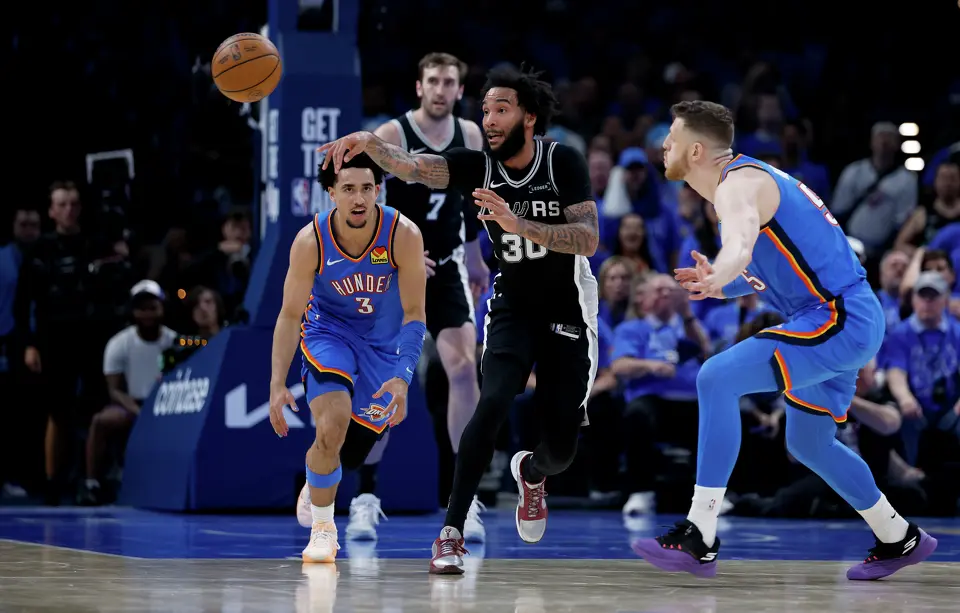 San Antonio Spurs forward Julian Champagnie (30) passes off the ball during the third quarter of Game 1 of the Western Conference Finals at Paycom Center in Oklahoma City, Monday, May 18, 2026.