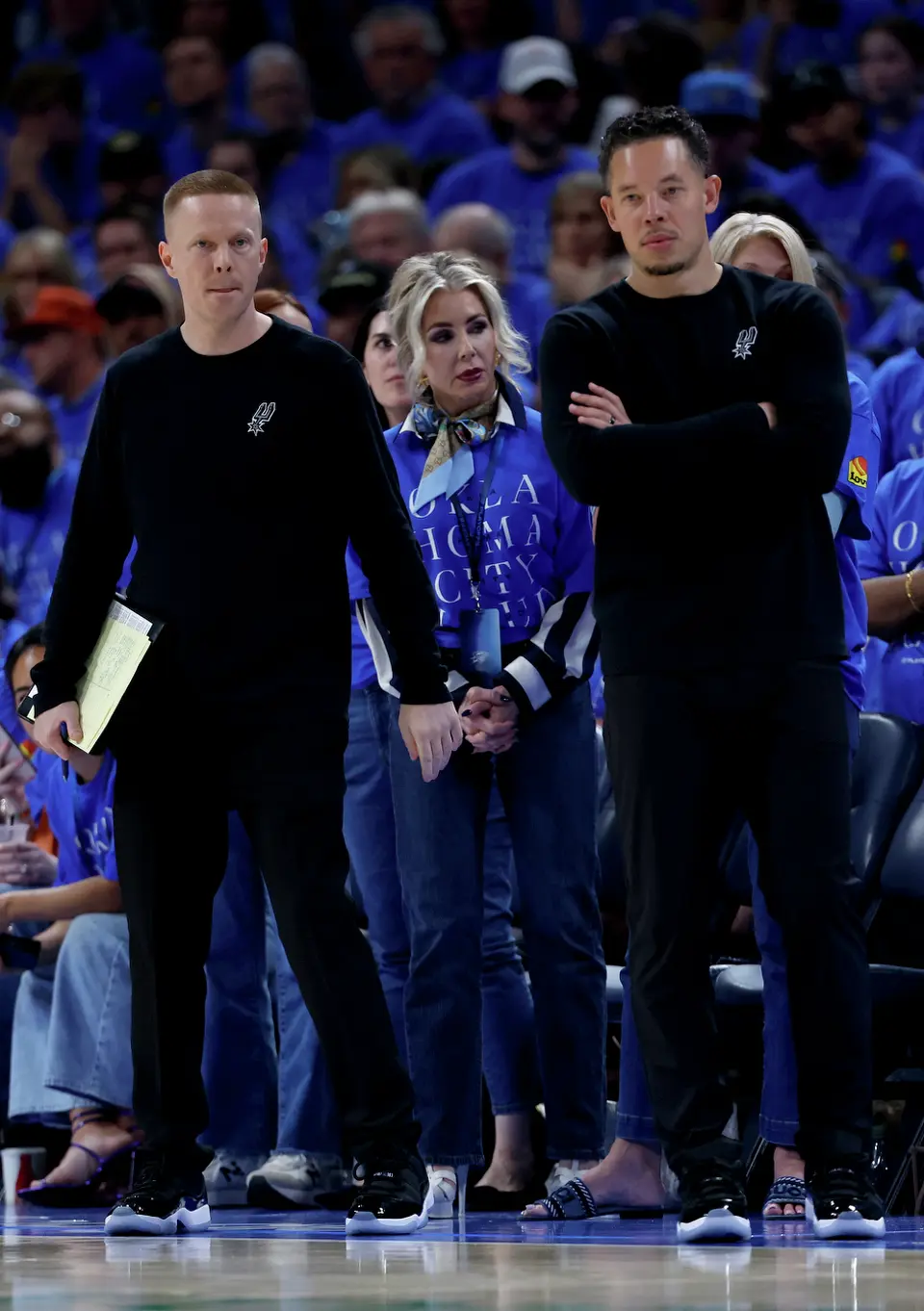 San Antonio Spurs head coach Mitch Johnson, right, looks on during the third quarter of Game 1 of the Western Conference Finals at Paycom Center in Oklahoma City, Monday, May 18, 2026.