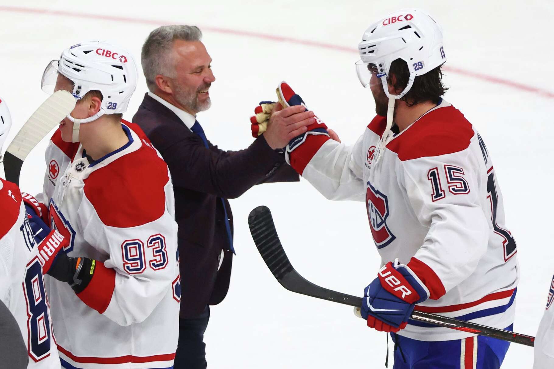 Montreal Canadiens head coach Martin St. Louis shakes hands with Montreal Canadiens center Alex Newhook (15) following the overtime period in Game 7 of a second-round NHL hockey Stanley Cup playoff series against the Buffalo Sabres, Monday, May 18, 2026, in Buffalo, N.Y.