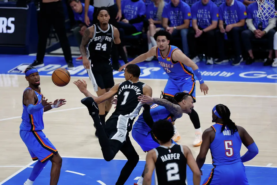 San Antonio Spurs forward Victor Wembanyama (1) and Oklahoma City Thunder players scramble to recover a loose ball during the second half of Game 1 of the Western Conference Finals at Paycom Center in Oklahoma City, Monday, May 18, 2026. The Spurs defeated the Thunder 122-115 in double overtime.