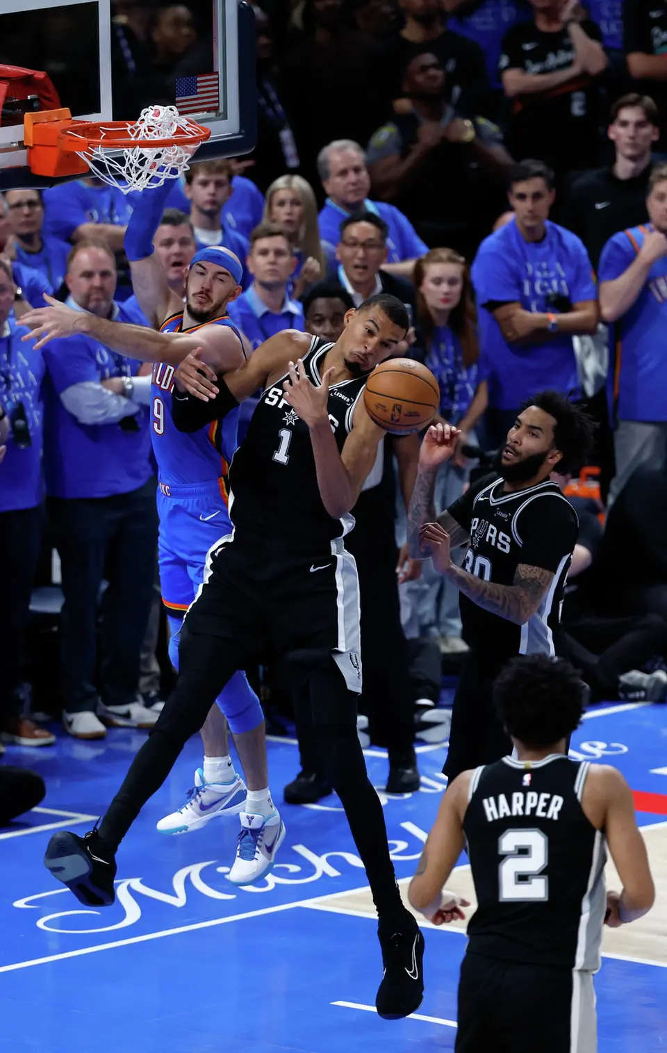 San Antonio Spurs forward Victor Wembanyama (1) and Oklahoma City Thunder guard Alex Caruso (9) battle for a rebound during the second overtime of Game 1 of the Western Conference Finals at Paycom Center in Oklahoma City, Monday, May 18, 2026. The Spurs defeated the Thunder 122-115 in double overtime.