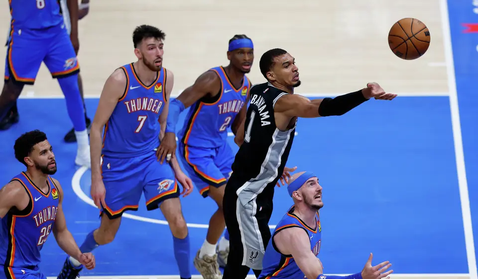 San Antonio Spurs forward Victor Wembanyama (1) and Oklahoma City Thunder guard Alex Caruso (9) battle under the basket during the second half of Game 1 of the Western Conference Finals at Paycom Center in Oklahoma City, Monday, May 18, 2026. The Spurs defeated the Thunder 122-115 in double overtime.