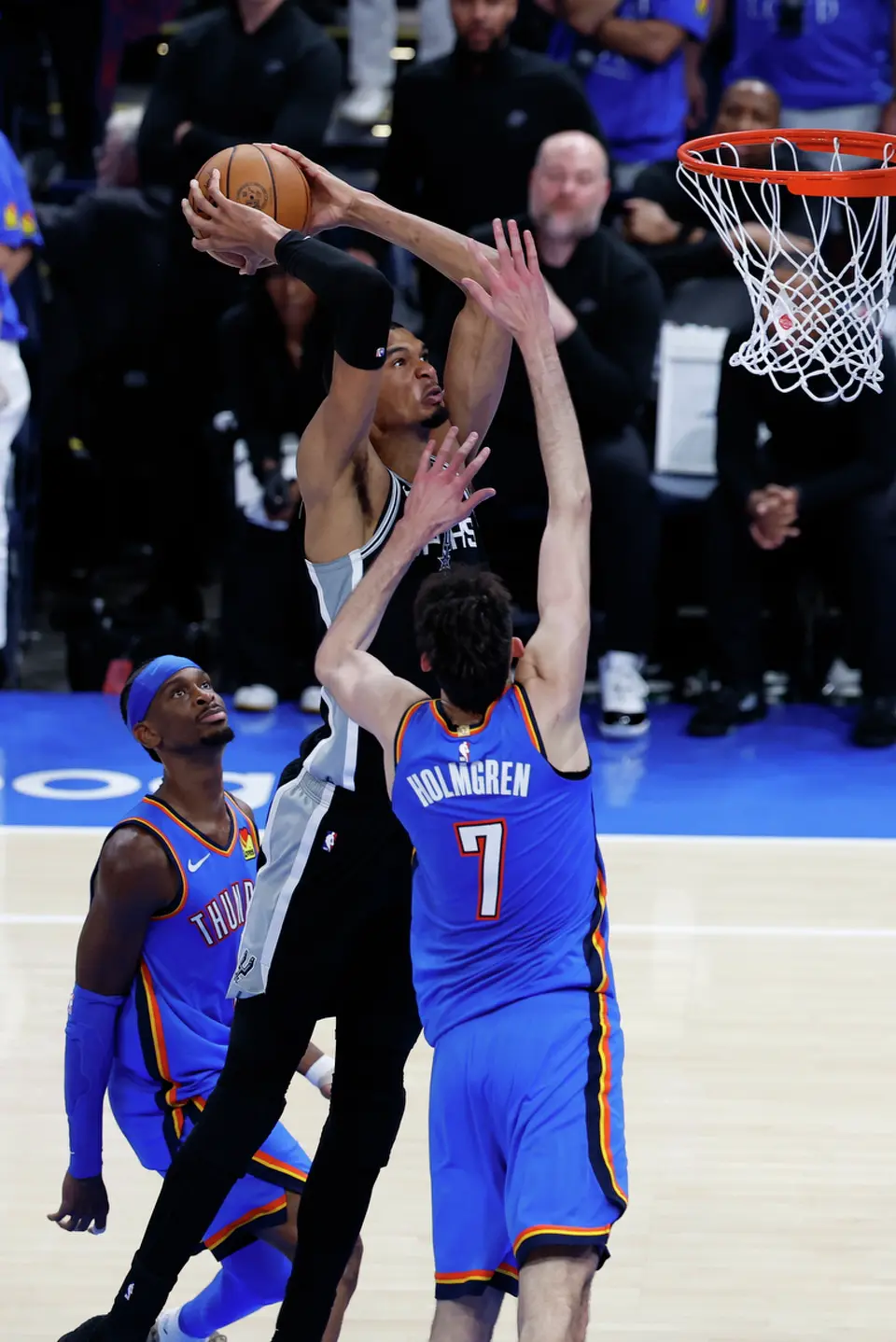 San Antonio Spurs forward Victor Wembanyama (1) slams the ball over Oklahoma City Thunder center Chet Holmgren (7) during the second half of Game 1 of the Western Conference Finals at Paycom Center in Oklahoma City, Monday, May 18, 2026. The Spurs defeated the Thunder 122-115 in double overtime.