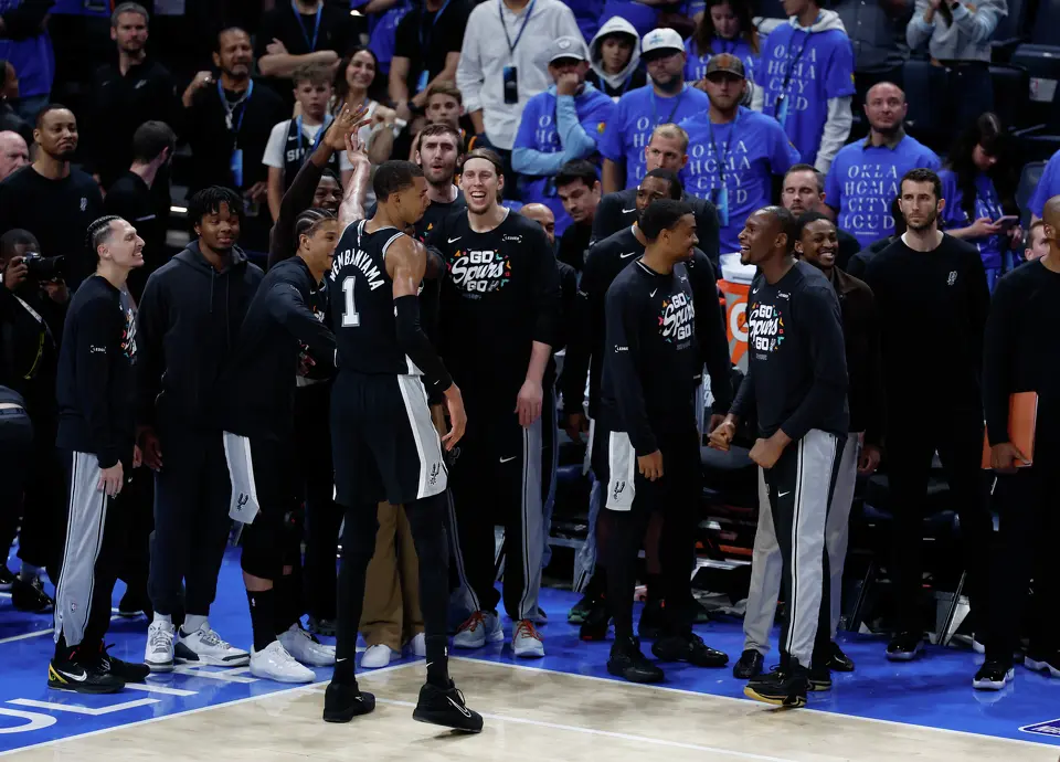 San Antonio Spurs forward Victor Wembanyama (1) struck a pose after a key blocked shot, cheered on by the Spurs bench during the second overtime of Game 1 of the Western Conference Finals at Paycom Center in Oklahoma City, Monday, May 18, 2026. The Spurs defeated the Thunder 122-115 in double overtime.