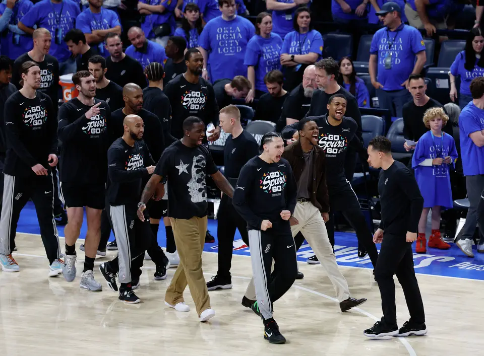 The Spurs bench erupts in celebration after taking the lead over the Oklahoma City Thunder in the second overtime period. The Spurs defeated the Thunder 122-155 in double overtime of Game 1 of the Western Conference Finals at Paycom Center in Oklahoma City, Monday, May 18, 2026.