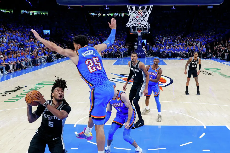 San Antonio Spurs guard Stephon Castle (5) goes up for a shot as Oklahoma City Thunder guard Ajay Mitchell (25) flies over him during Game 1 of the Western Conference Finals at Paycom Center in Oklahoma City, Monday, May 18, 2026. The Spurs defeated the Thunder 122-115 in double overtime.