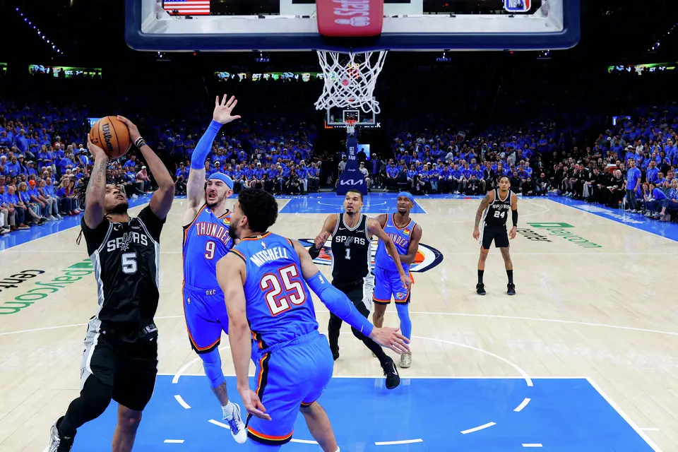 San Antonio Spurs guard Stephon Castle (5) goes up for a shot over Oklahoma City Thunder guard Alex Caruso (9) and guard Ajay Mitchell (25) during Game 1 of the Western Conference Finals at Paycom Center in Oklahoma City, Monday, May 18, 2026. The Spurs defeated the Thunder 122-115 in double overtime.