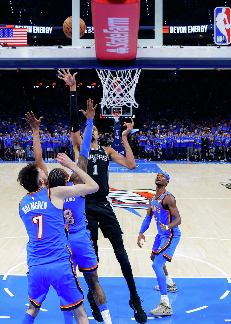 San Antonio Spurs forward Victor Wembanyama (1) makes a shot over Oklahoma City Thunder center Chet Holmgren (7) and guard Jalen Williams (8) during Game 1 of the Western Conference Finals at Paycom Center in Oklahoma City, Monday, May 18, 2026. The Spurs defeated the Thunder 122-115 in double overtime.