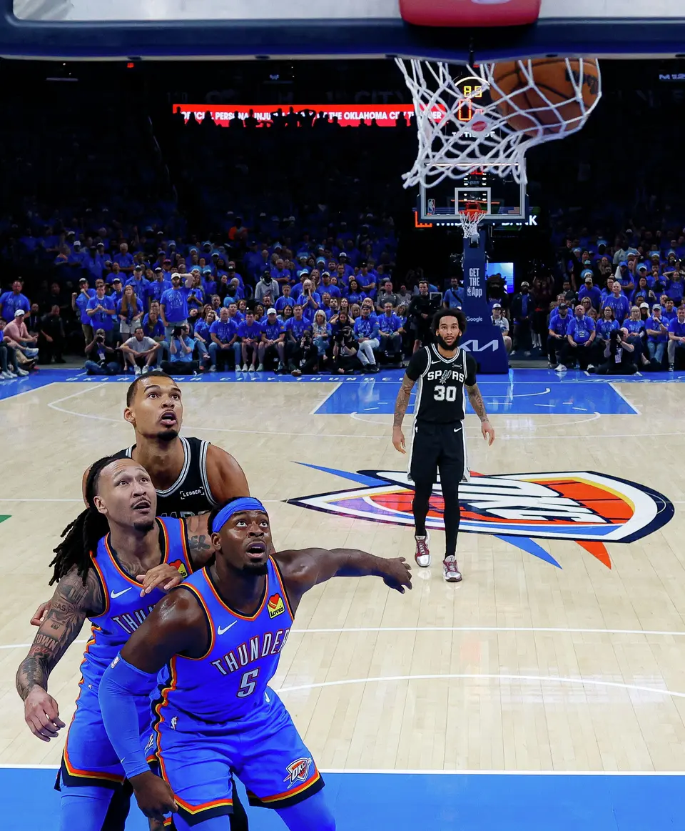 San Antonio Spurs forward Victor Wembanyama (1), Oklahoma City Thunder forward Jaylin Williams (6) and guard Luguentz Dort (5) watch a Spurs ball go in during Game 1 of the Western Conference Finals at Paycom Center in Oklahoma City, Monday, May 18, 2026. The Spurs defeated the Thunder 122-115 in double overtime.