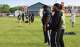 Michigan Arsenal arena football players call out encouragement as their teammates practice with the Golden Knights Special Olympics flag football team outside Midland High School on May 18, 2026. The Golden Knights are headed to the Special Olympics USA Games in Minnesota on June 18.