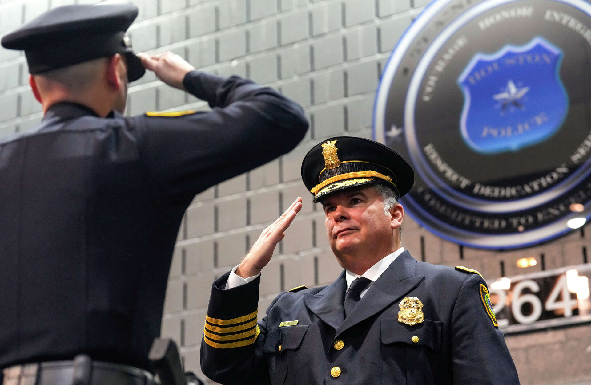 Houston Police Chief Noe Diaz salutes a new police officer during the graduation ceremony for Houston Police Academy Cadet Class 264 in August.