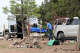 Workers remove a body in Mountainair, N.M., Wednesday, May 20, 2026, after several people died and more than a dozen first responders were exposed to an unknown substance.
