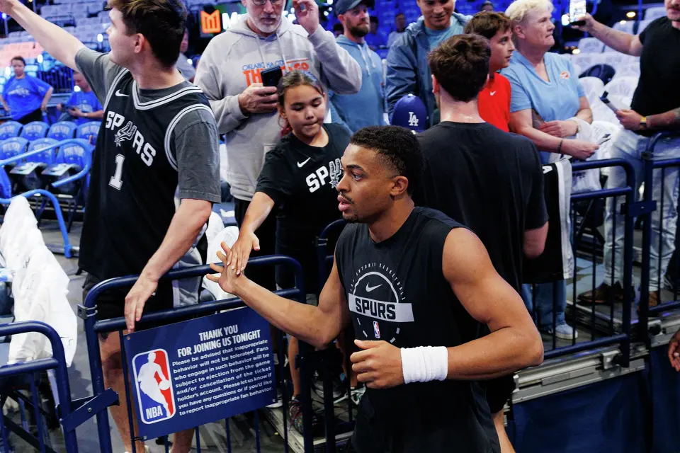 San Antonio Spurs forward Keldon Johnson slaps hands with a fan as he runs onto the court for a pre-game warmup before Game 2 of the Western Conference Finals against the Oklahoma City Thunder at Paycom Center in Oklahoma City, Wednesday, May 20, 2026.