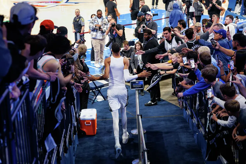 San Antonio Spurs forward Victor Wembanyama (1) slaps hands with fans as he runs onto the court for a pre-game warmup before Game 2 of the Western Conference Finals against the Oklahoma City Thunder at Paycom Center in Oklahoma City, Wednesday, May 20, 2026.