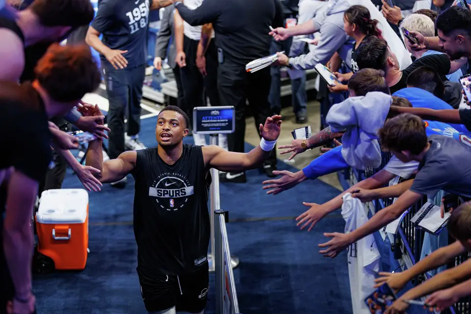 San Antonio Spurs forward Keldon Johnson slaps hands with a fan as he runs back to the locker room before Game 2 of the Western Conference Finals against the Oklahoma City Thunder at Paycom Center in Oklahoma City, Wednesday, May 20, 2026.