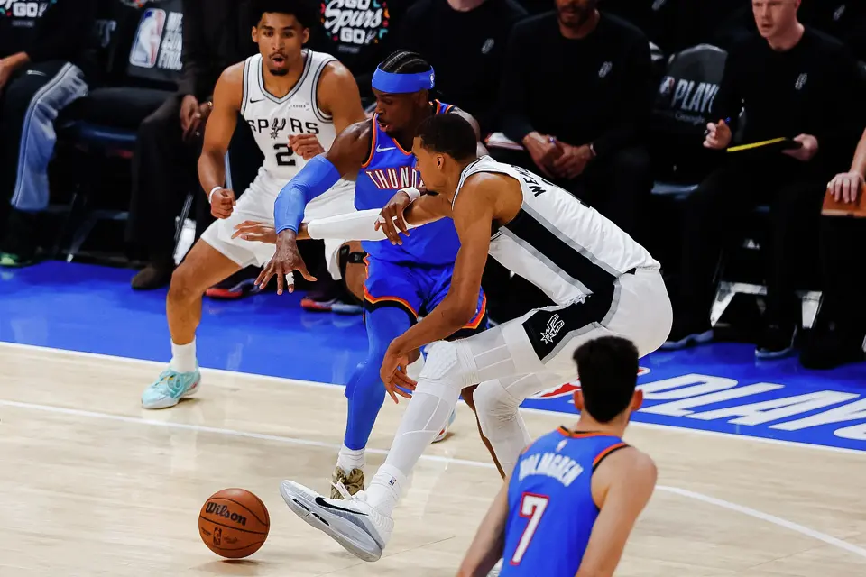 San Antonio Spurs forward Victor Wembanyama (1) and Oklahoma City Thunder guard Shai Gilgeous-Alexander (2) reach for the ball during the first half of Game 2 of the Western Conference Finals at Paycom Center in Oklahoma City, Wednesday, May 20, 2026.