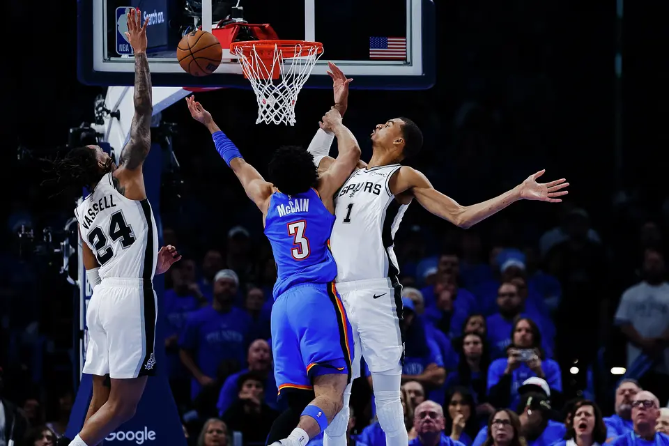 San Antonio Spurs guard Devin Vassell (24), San Antonio Spurs forward Victor Wembanyama (1) and Oklahoma City Thunder guard Jared McCain (3) go up to the net during the third quarter of Game 2 of the Western Conference Finals at Paycom Center in Oklahoma City, Wednesday, May 20, 2026.