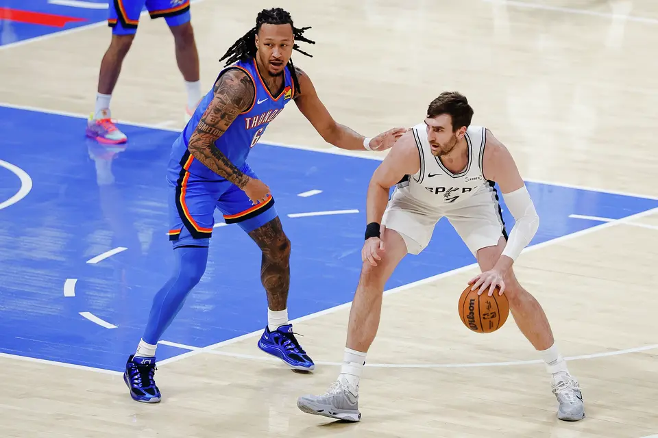 San Antonio Spurs center Luke Kornet (7) dribbles there ball around Oklahoma City Thunder forward Jaylin Williams (6) during the first half of Game 2 of the Western Conference Finals at Paycom Center in Oklahoma City, Wednesday, May 20, 2026.