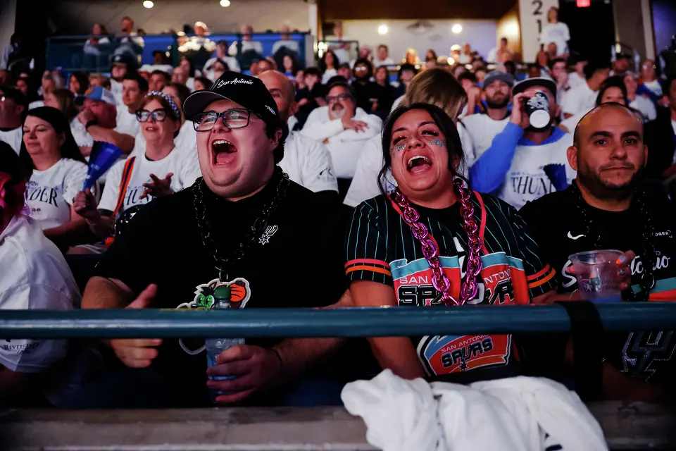 Spurs fans Marcos Alvarado, left, and Abigail Rios cheer on the Spurs during the first half of Game 2 of the Western Conference Finals at Paycom Center in Oklahoma City, Wednesday, May 20, 2026.