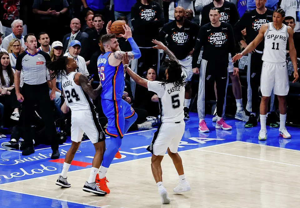 Oklahoma City Thunder center Isaiah Hartenstein (55) tries to get around San Antonio Spurs guard Devin Vassell (24) and San Antonio Spurs guard Stephon Castle (5) during the fourth quarter of Game 2 of the Western Conference Finals at Paycom Center in Oklahoma City, Wednesday, May 20, 2026. The San Antonio Spurs fell 122-113 to the Oklahoma City Thunder.