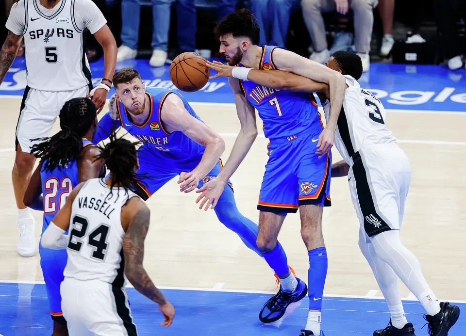 San Antonio Spurs forward Keldon Johnson (3) reaches for the ball while entangled with Oklahoma City Thunder center Chet Holmgren (7) as Oklahoma City Thunder guard Luguentz Dort (5) looks at the ball during the fourth quarter of Game 2 of the Western Conference Finals at Paycom Center in Oklahoma City, Wednesday, May 20, 2026. The San Antonio Spurs fell 122-113 to the Oklahoma City Thunder.